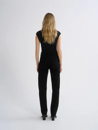 Back view of the AGOLDE Agata Bodysuit in Black worn with black straight leg jeans.
