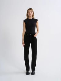 Full-length front view of the AGOLDE Agata Bodysuit in Black styled with black jeans and ankle boots.
