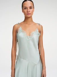 Close-up of the lace-trimmed V-neckline and tie straps on the A.L.C. Aleena Dress in Pale Jade