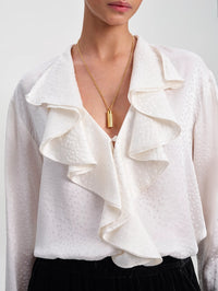 Close-up of the ruffled front closure and dot jacquard on the A.L.C. Colette Top in Ivory.
