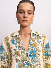 Front view of the Sophia Top in Multi Soph by ALEMAIS, featuring a blue and yellow floral print with tie-front neckline