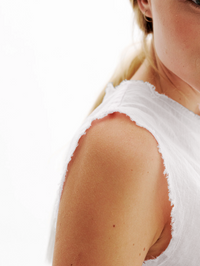 Close-up of the textured gauze shoulder detail on the Iris Gauze Tank in white by ALL THREE