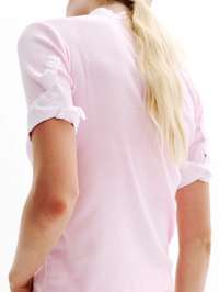 Back view of the Maria Rib Henley Shirt in Light Pink by All Three with rolled short sleeves