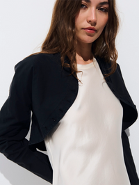 Front view of the Olivia Poplin Bolero in black by ALL THREE, layered over a white tank