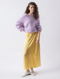 Full-length view of the Bovalow Skirt in Marthe by American Vintage, styled with a lavender knit sweater