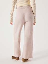 Back view of the Damsville Pant in Poussière Chine by American Vintage, styled with a cream long-sleeve top