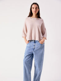 Model wearing the American Vintage Damsville sweater in Melange Dust with light wash jeans