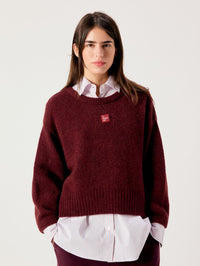 Front view of the American Vintage East alpaca blend sweater in Melange Acerola over a striped shirt