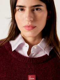 Close up of the neckline and front patch on the American Vintage East sweater in Melange Acerola