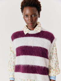 Front view of the American Vintage Niby striped sweater vest in Cranberry Stripes over a floral shirt