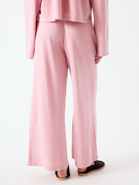 Back view of the Pojy Pant in Eglantine Vintage pink by American Vintage, paired with black slip-ons