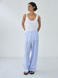 Front view of the Vibtown Tank in Blanc Vintage by American Vintage, styled with light blue wide-leg pants