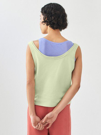 Back view of the Vibtown Tank in Tilleul Vintage by American Vintage, layered over a purple tee
