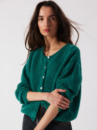 Three quarter view of the American Vintage Vitow Cardigan in Teal Melange with pearl effect buttons