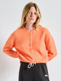 Front view of the Vitow Sweater in Carotte Fluo Chine by American Vintage, styled with black track pants