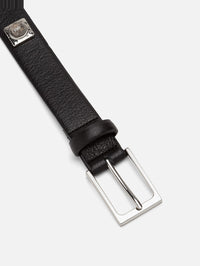Buckle detail of the Aureum No. 2 Belt in black leather with a silver-tone buckle and speckled stone stud.