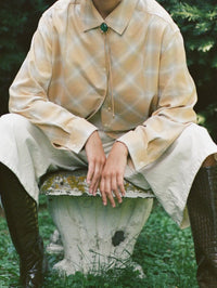 Lola Bolo in Gold with Malachite worn at the collar of a plaid shirt, BOLOLA NYC.