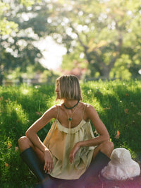 Model wearing the BOLOLA NYC Lola Bolo in Gold with Malachite over a camisole outdoors.
