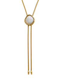 Close-up of the hammered gold frame and stone on the BOLOLA NYC Lola bolo necklace in gold with mother of pearl.