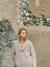 Model wearing the BOLOLA NYC Lola Bolo in Gold with Tigers Eye over a deep V sweater.
