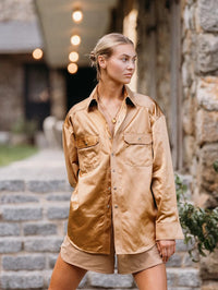 Model wearing the BOLOLA NYC Lolita Bolo in Gold with Citrine under a satin shirt collar.