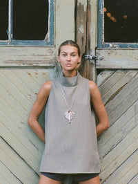 Model wearing the BOLOLA NYC Palmette Bolo in Silver with Citrine over a gray mock neck top.