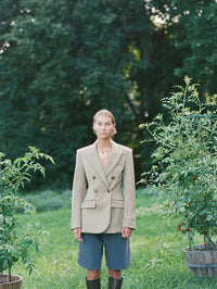 Styled shot of the BOLOLA NYC Palmette Bolo in Gold with Smokey Topaz under a beige blazer.
