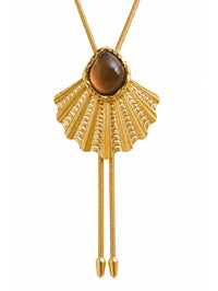 Close-up of the smokey topaz and diamond studded fan on the BOLOLA NYC Palmette Bolo in Gold.