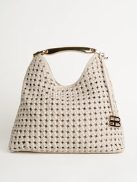 Front view of the Bronx and Banco braided leather shoulder bag in White with curved gold handle and logo charm.