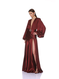 Side angle of the Bronx and Banco burgundy maxi dress with blouson sleeves and plunging neckline.