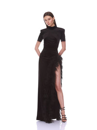 Front pose showing the feather-edged leg slit on the Bronx and Banco black velvet maxi dress.