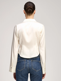 Back view of the Le Petit Petra Top in ivory by Cinq à Sept, styled with dark denim