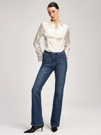 Front view of the Le Petit Petra Top in ivory by Cinq à Sept, styled with dark wash jeans