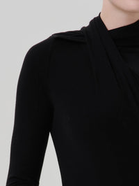 Close up of the asymmetrical wrap at the neck of the Citizens of Humanity Sculptural Bodysuit in Black.