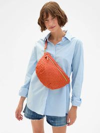 Front view of the Grande Fanny in Medium Woven Diagonal crossbody bag in Saltillo by Clare V., styled with a light blue shirt