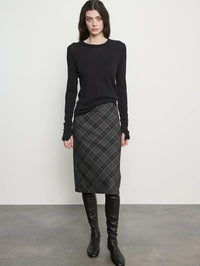 Front view of the Enza Costa Bias Minimal Skirt in Charcoal Plaid styled with a black crewneck and tall boots.