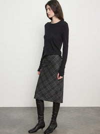 Side view of the Enza Costa Bias Minimal Skirt in Charcoal Plaid showing the midi length and diagonal plaid.