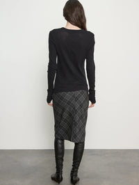 Back view of the Enza Costa Bias Minimal Skirt in Charcoal Plaid on a model in black boots.
