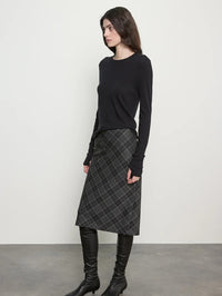 Side view of the Enza Costa Bias Minimal Skirt in Charcoal Plaid showing the midi length and diagonal plaid.