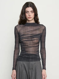 Close front view of the ruched bodice on the Enza Costa Plaid Mesh Long Sleeve Twist Top in Shadow Plaid.