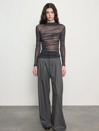 Full front view of the Enza Costa Plaid Mesh Long Sleeve Twist Top in Shadow Plaid with grey wide leg trousers.