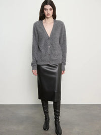 Front view of the Enza Costa Mink Wash Cashmere Cardigan in Pewter, worn buttoned with a black leather skirt.
