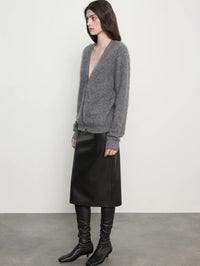 Side view of the Enza Costa Mink Wash Cashmere Cardigan in Pewter showing its V-neck and relaxed sleeves.