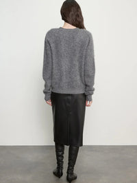 Back view of the Enza Costa Mink Wash Cashmere Cardigan in Pewter with a black leather skirt and boots.