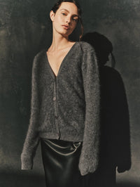 Editorial shot of the Enza Costa Mink Wash Cashmere Cardigan in Pewter showing its brushed cashmere texture.