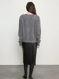 Back view of the Enza Costa Mink Wash Cashmere Cardigan in Pewter with a leather skirt and tall boots.