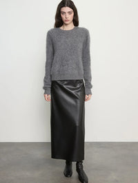 Front view of the Enza Costa Mink Wash Cashmere Easy Crew in Pewter styled with a black leather midi skirt.