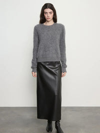 Full front view of the Enza Costa Mink Wash Cashmere Easy Crew in Pewter with a black leather midi skirt.