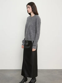 Side view of the Enza Costa Mink Wash Cashmere Easy Crew in Pewter showing the relaxed sleeve and hem.