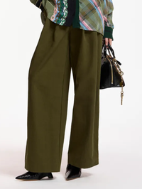 Front view of the Korrupt Studded Pants in dusty green by Essentiel Antwerp, styled with a plaid jacket